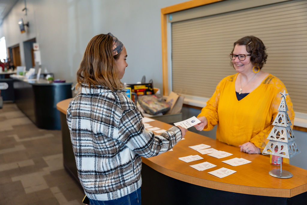 A guest being welcomed at a reception desk