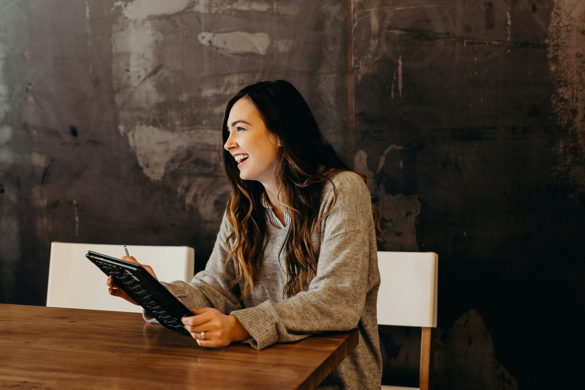 A nonprofit leader smiling while reviewing marketing plans on a tablet