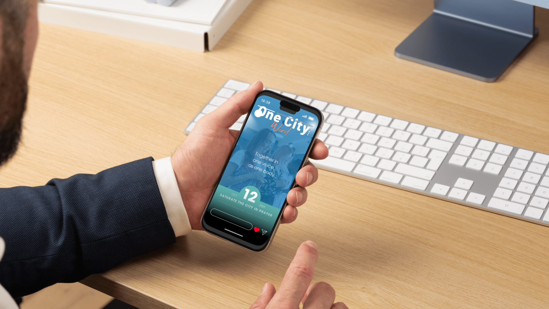 Hand holding a phone showing a nonprofit social post
