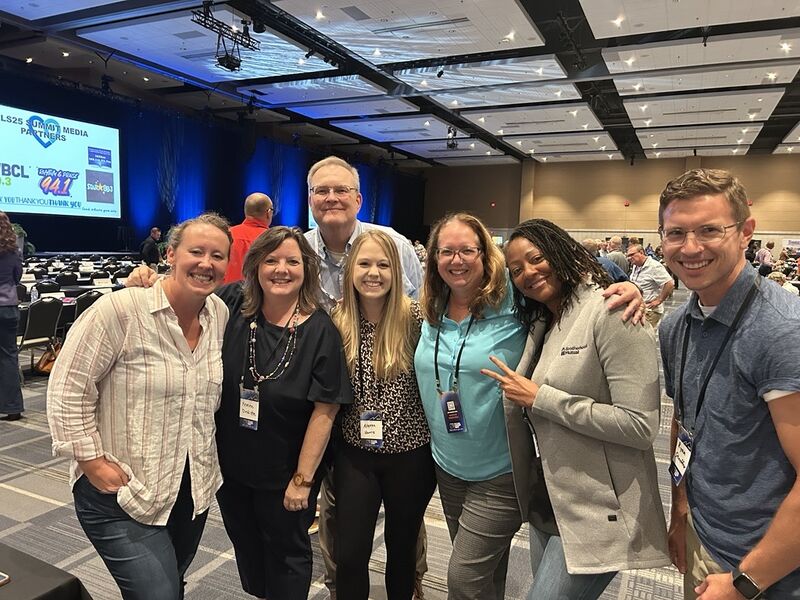 Team of mission-driven professionals gathered at a conference