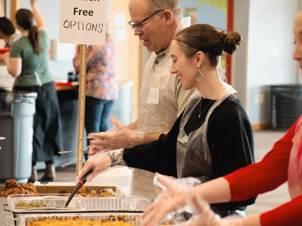 Volunteers serving food at a community outreach event