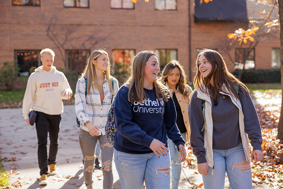 Students walking together on the Bethel University campus on a sunny fall day