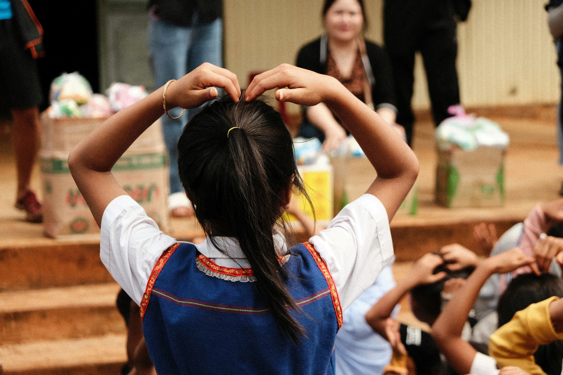 Child making a heart shape with hands