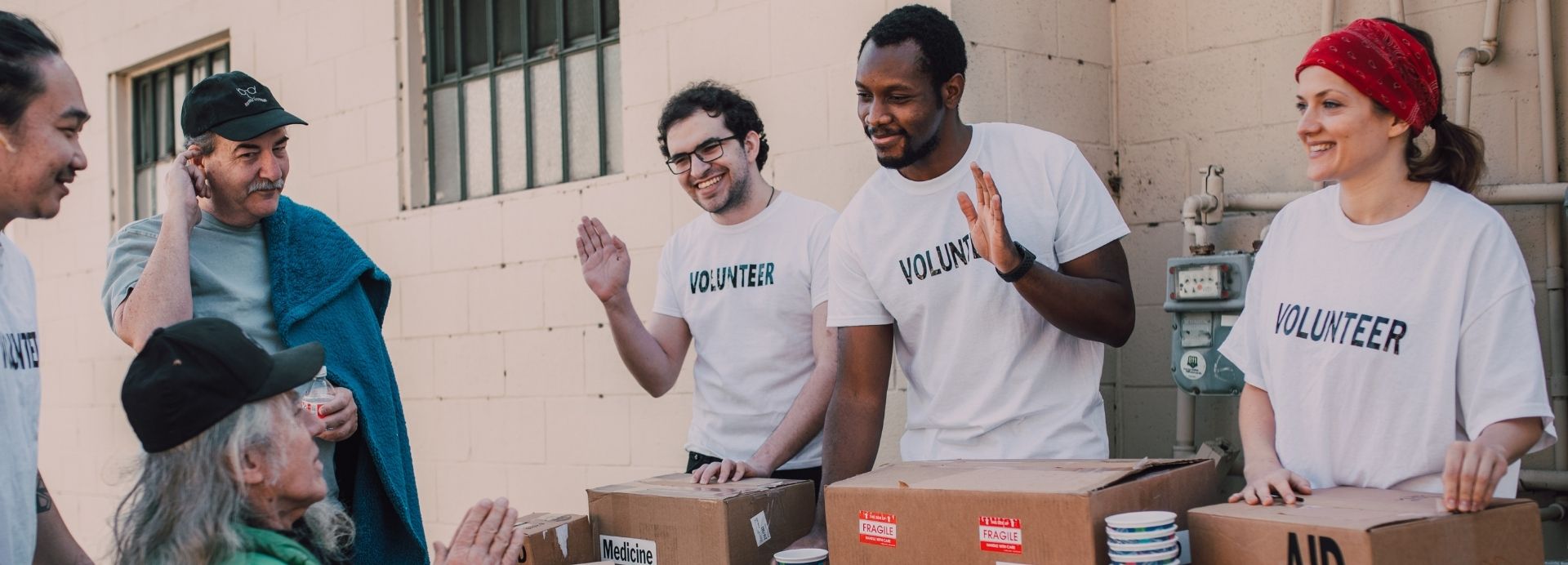 Volunteers greeting community members at an outreach event