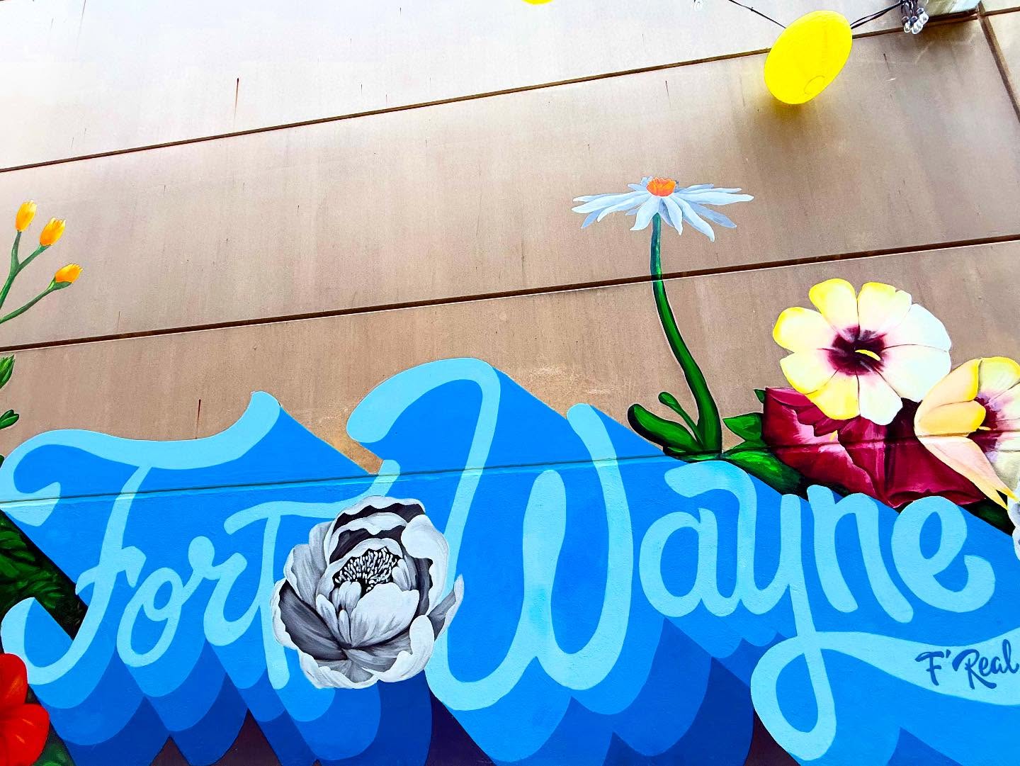 Colorful Fort Wayne mural with flowers and local artwork